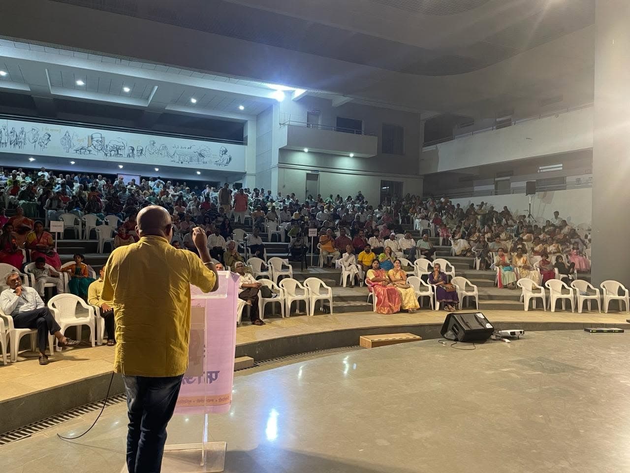 Manoj Deshmukh speaking to a hall of students and parents